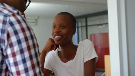 Front-view-of-young-black-businesswoman-interacting-with-colleague-in-a-modern-office-4k