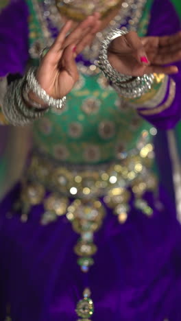 vertical video close up on hands of female kathak dancer performing dance wearing traditional indian dress 2