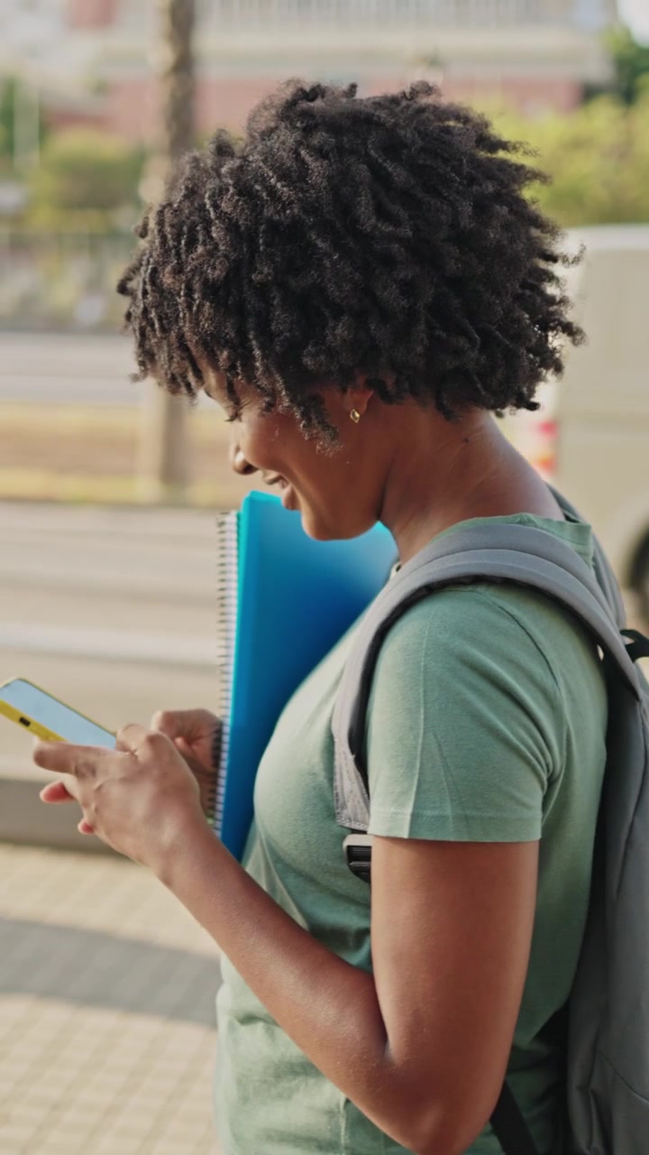 Happy Young African American Woman Using Smartphone Outdoors