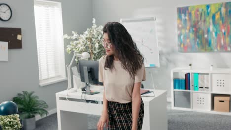 happy satisfied office worker got promotion she dances between desks in company, woman with korean beauty is cheerful, smiling, in a break from her duties she practices a new choreography