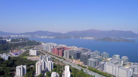 beautiful white colored science park with a wide highway in the background and a dense residential area with a beautiful view over the sha tin hoi bay in hong kong