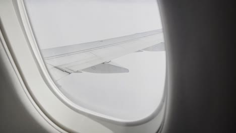 view of a plane wing while mid flight