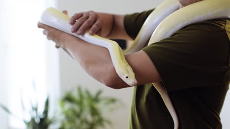 man with snake indoors