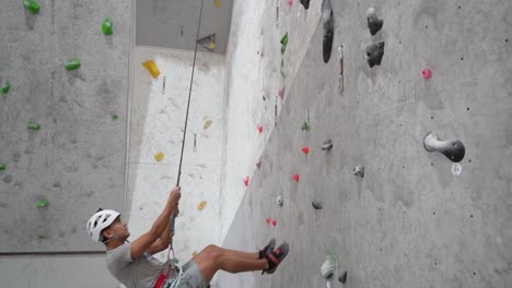 man indoor rock climbing