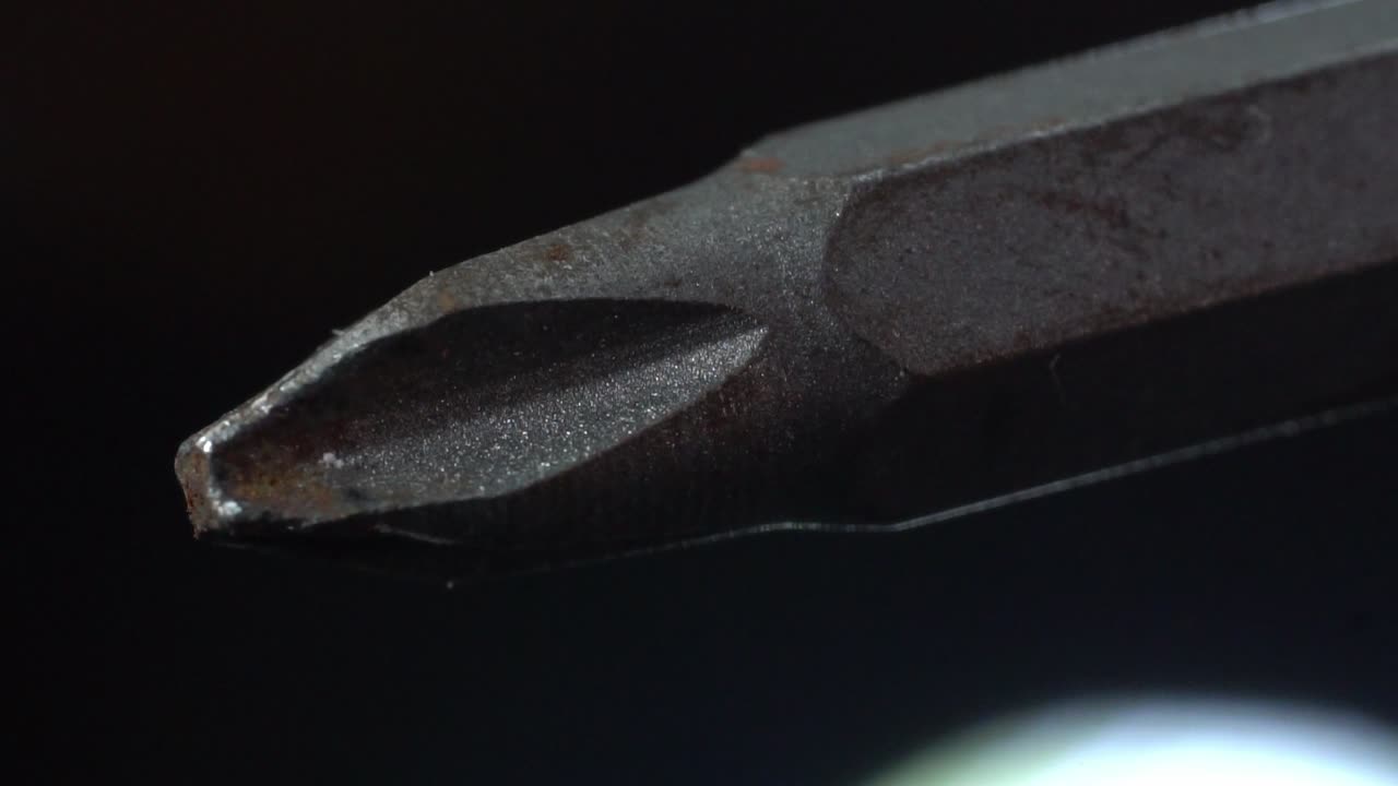 Hexagonal tip for electric screwdriver. Macro close up in black background