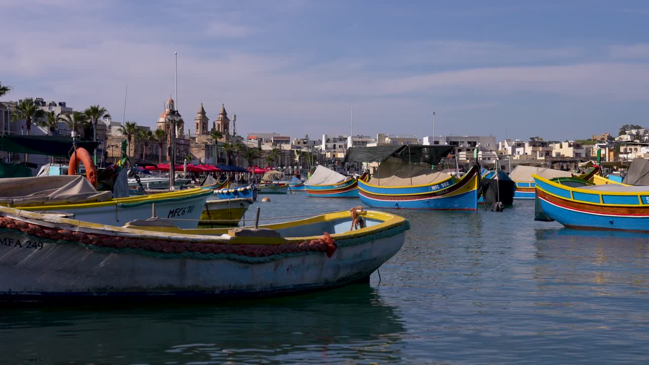 Countless colorful fishing boats &amp;quot;Luzzus&amp;quot; in picturesque fishing village of Marsaxlokk on Malta
