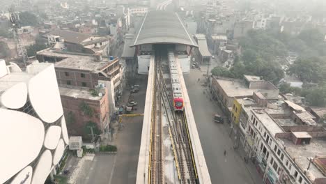 Orange-Line-Train-leaving-at-Lahore-Station,-Pakistan