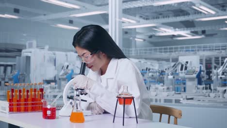 side view of asian woman scientist looking through a microscope then thinking, looking around, and raising index finger in the laboratory. working in the lab analyzing samples under microscope