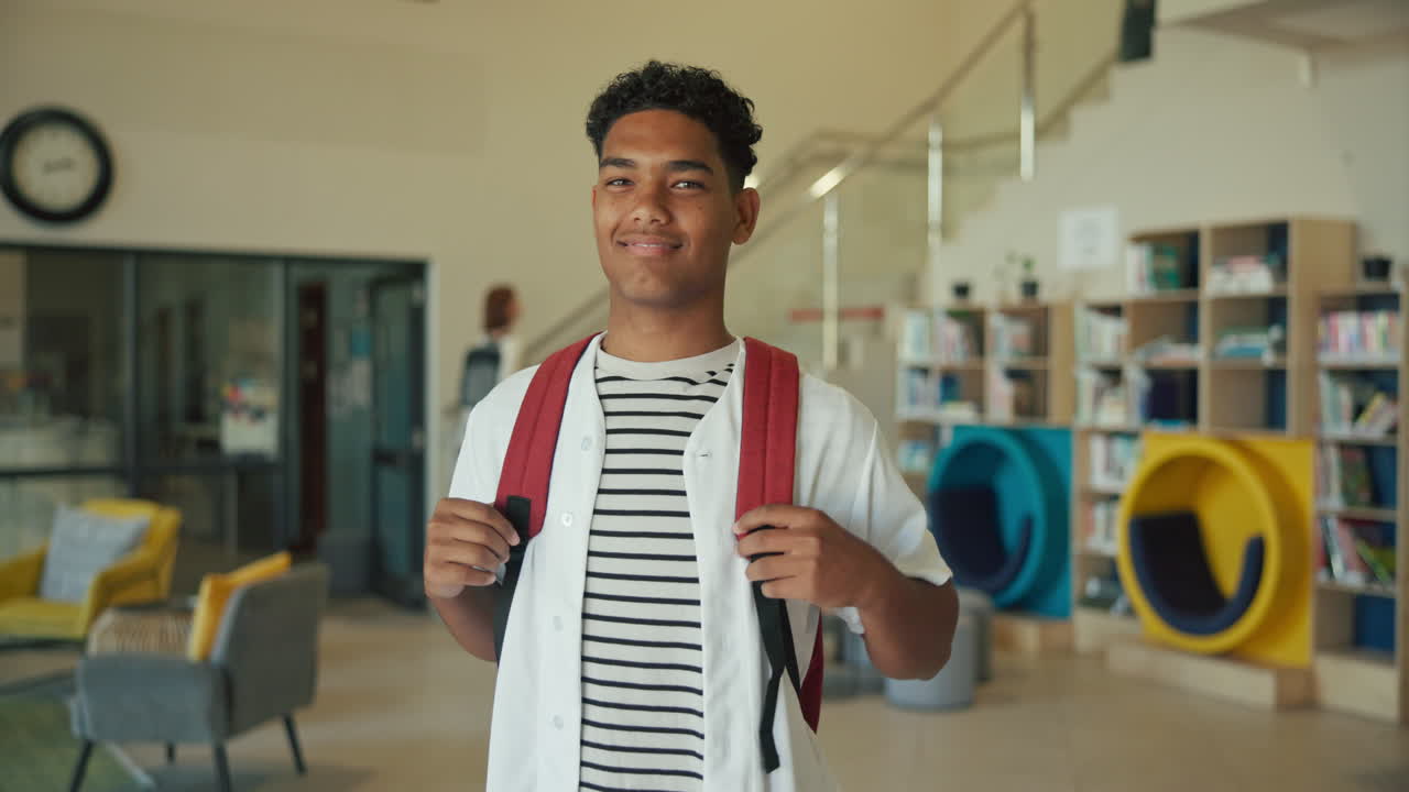 Teenage student with backpack in school library