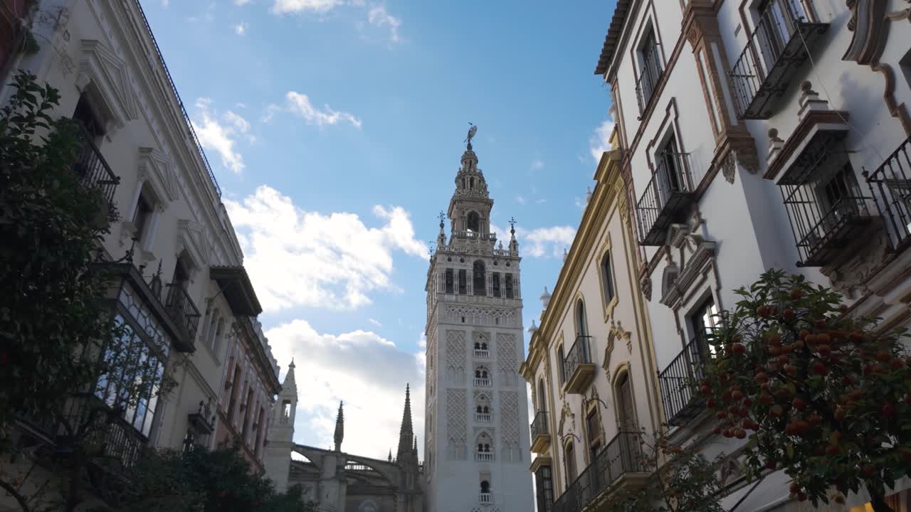 Dominating Seville's skyline, La Giralda showcases intricate Moorish architecture against a vibrant blue sky
