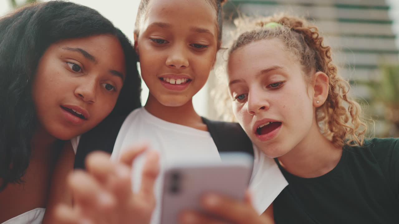 Three Girls Looking at a Phone