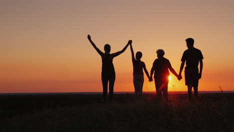 Active-Healthy-Family-Grandmother-With-Daughter-And-Grandchildren-Meet-The-Dawn-Raise-Their-Arms-Abo