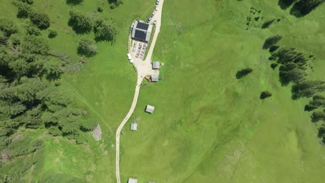 Birdseye-view-of-the-mountain-hut-Utaia-da-Rit-near-the-village-of-La-Val,-South-Tyrol,-Dolomites,-Italy