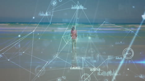animación de la red de conexiones con procesamiento de datos sobre mujer caucásica caminando por la playa