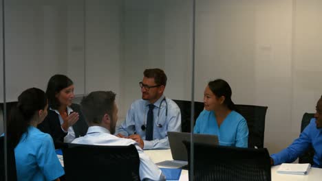 doctor interacting with colleagues in meeting