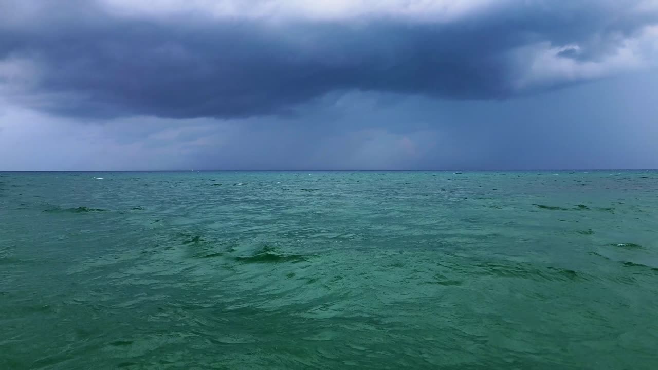 A storm brewing over the ocean along the beach.