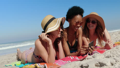 young female friends having fun at beach 4k