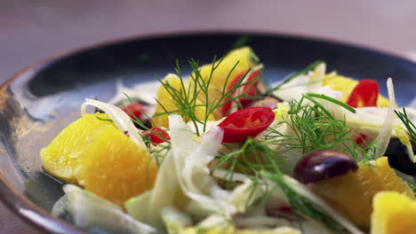 shaved fennel and orange salad on plate, close up pan