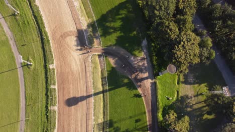 aerial top down view of race horses going into racecourse