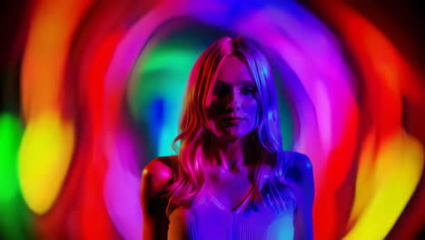 woman illuminated by vibrant abstract lights