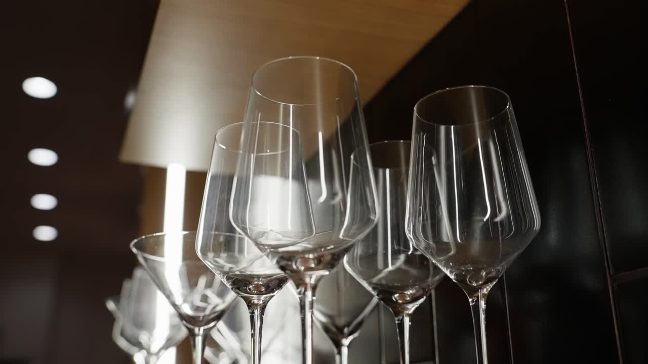 Dimly lit wine glasses on shelf with back light