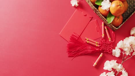 video of envelopes, oranges and flowers on red background