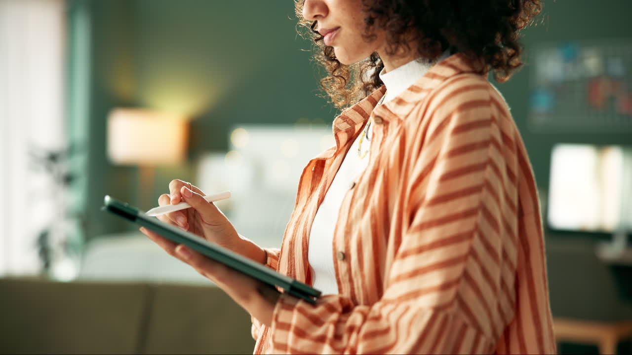 Woman working on tablet with stylus