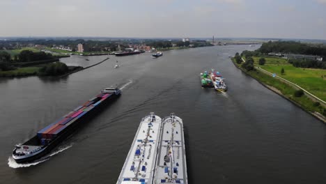 multiple barges sailing on a dutch river