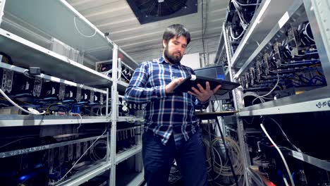 cryptocurrency specialist working monitoring mining process.