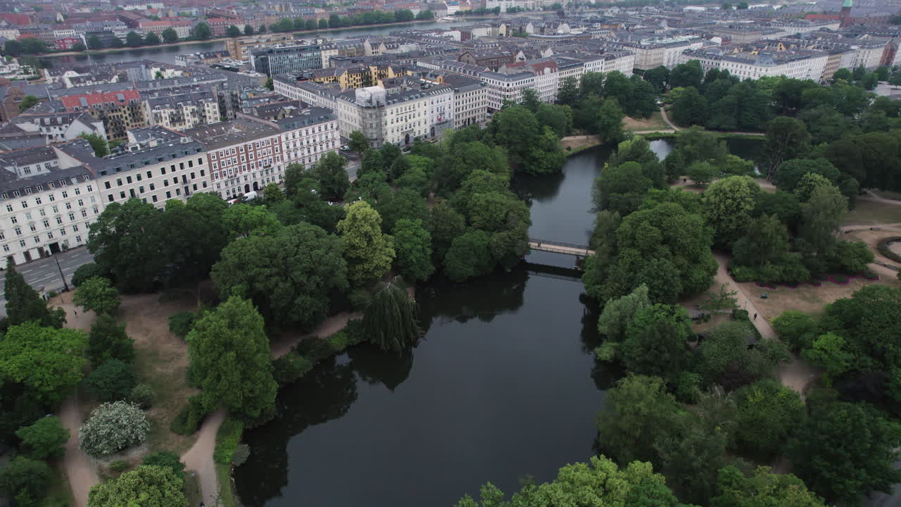 A bird's-eye view captures &Oslash;rstedsparken's natural beauty, as it harmoniously coexists with the cityscape, offering greenery and lakes in central Copenhagen