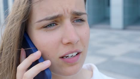 Close-up-of-young-woman-talking-on-the-phone,-in-Slow-Motion