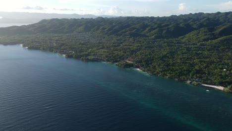 Aerial-idyllic-Southeast-Asian-Jungle-Beach-Waterfront-Landscape-of-Green-Hills-only-Nature-in-Summer-Morning-Sunshine