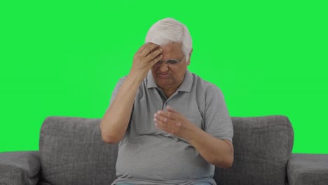 Sick-Indian-old-man-suffering-from-headache-Green-screen