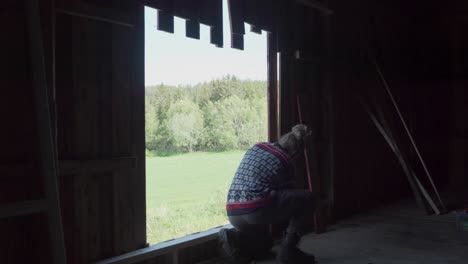 man worker cutting wooden walls inside the renovating barn house