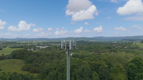 cell tower amidst lush green landscape and sky