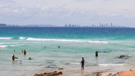 people enjoying the ocean on a sunny beach day