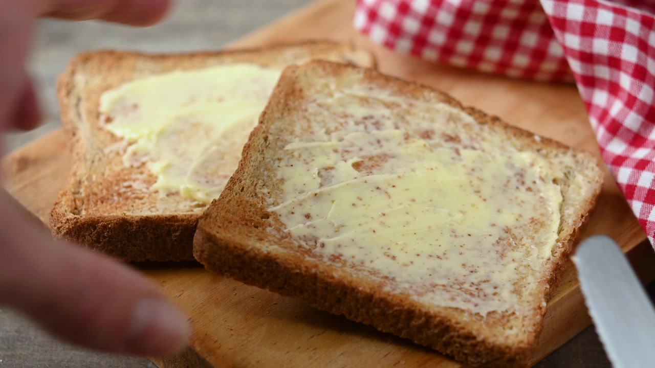 Spreading Butter on a Slice of Whole Wheat Toast