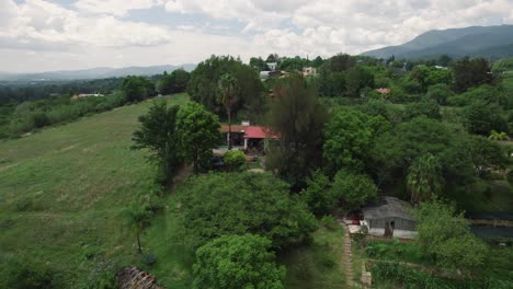 distancing aerial of small house hidden in natural environment of settlement etla in mexico