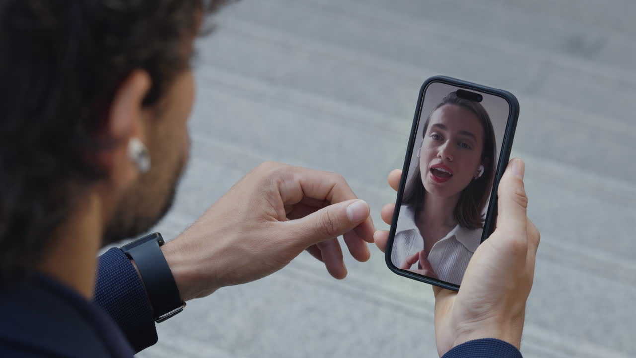 Man Engaged in Video Call on Smartphone with Woman