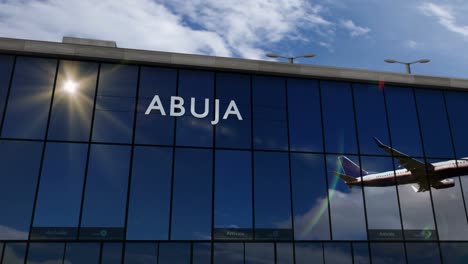 airplane landing at abuja nigeria airport mirrored in terminal