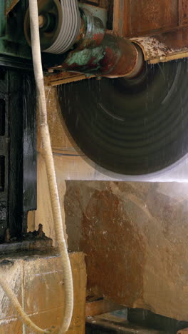 automatic machine with water supply is cutting cobble on the manufacturing. stone processing vertical video