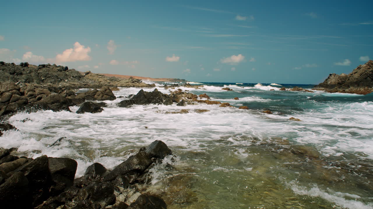 Waves crash into rocks at Conchi, natural pools