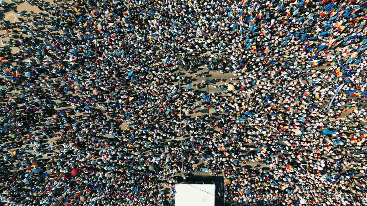 CHISINAU, MOLDOVA - 21 MAY, 2023: Aerial drone view of the rally in support of the country's European integration in Chisinau, Moldova. Thousands of people in the city downtown, greenery, EU and national flags