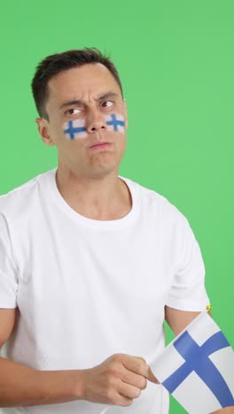 nervous man cheering for finland during a match looking away