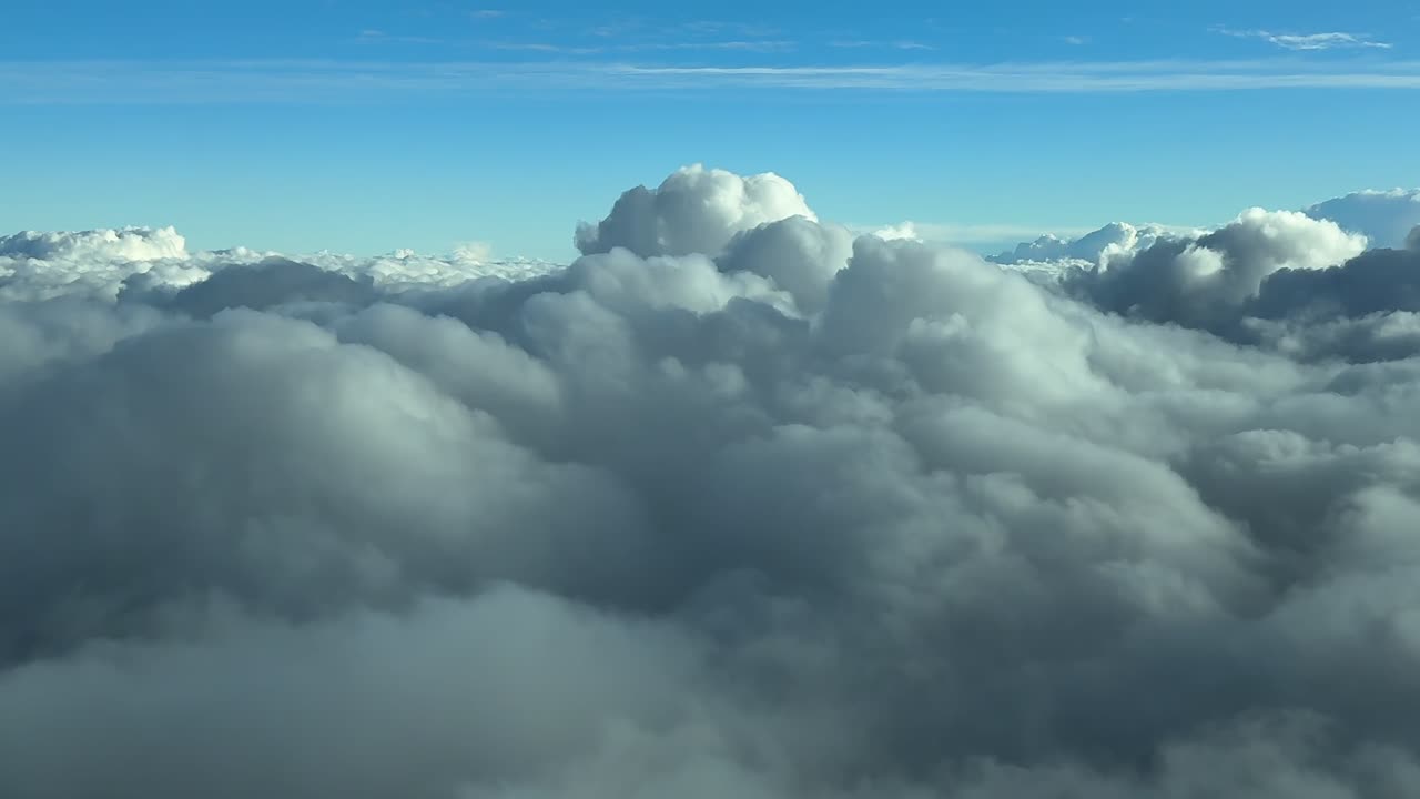 An immersive cloud immersion view captured from a jet airplane cockpit descending through the clouds