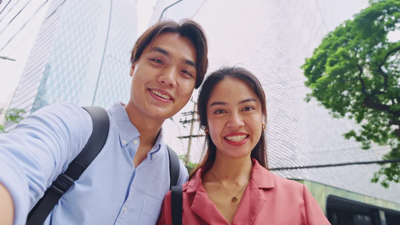 Two people smiling in the city