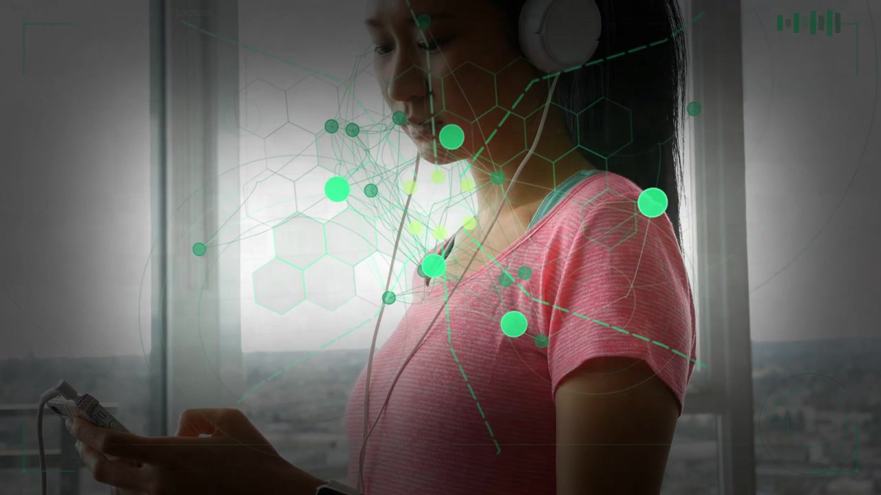 Woman tapping phone by window starting green tech overlay on torso while wearing cans for listening