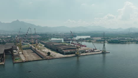 Aerial-birds-eye-view-Rio-de-Janeiro-industrial-sea-port-panorama-with-cranes-and-docks-on-guanabara-bay