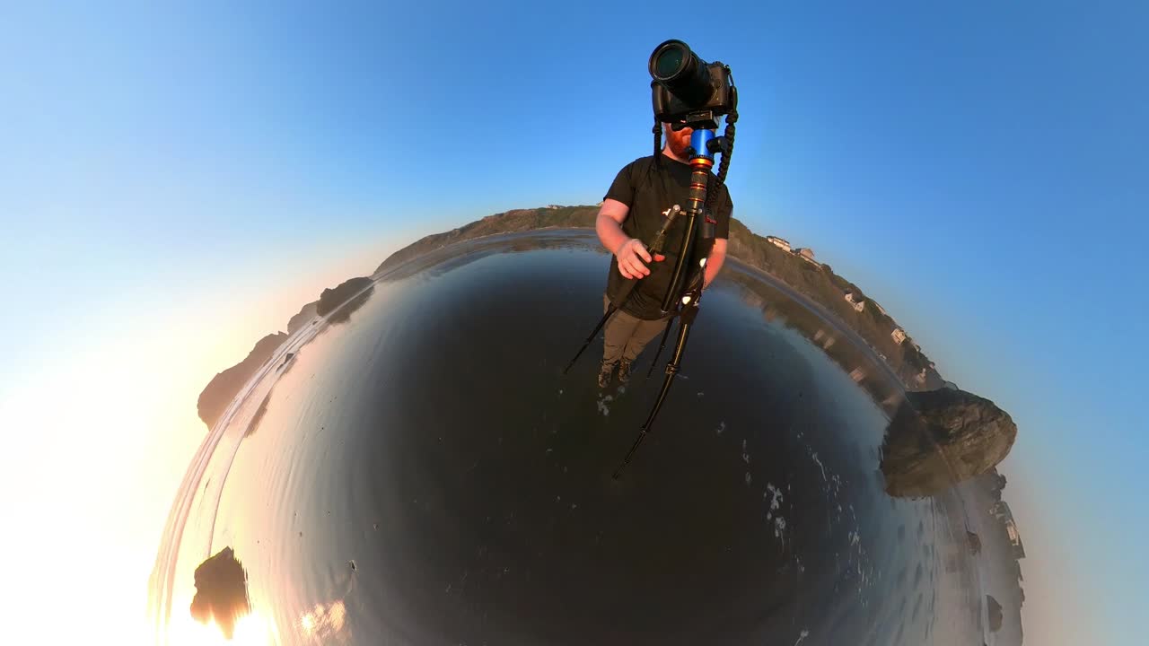 A photographer working on Bandon Beach during golden hour