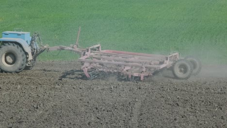 a tractor plowing a dry agricultural field, preparing land for planting. agricultural industry. processing the field on the farm.